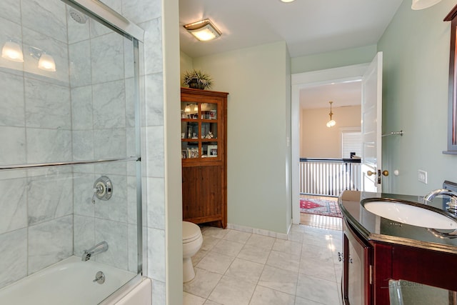 full bathroom with baseboards, toilet, enclosed tub / shower combo, tile patterned floors, and vanity