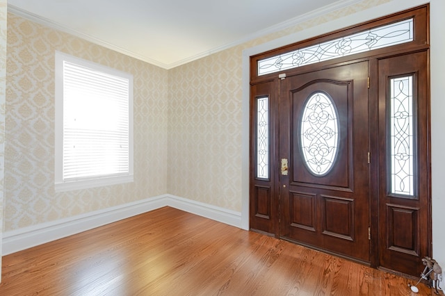 foyer entrance featuring light hardwood / wood-style flooring and ornamental molding