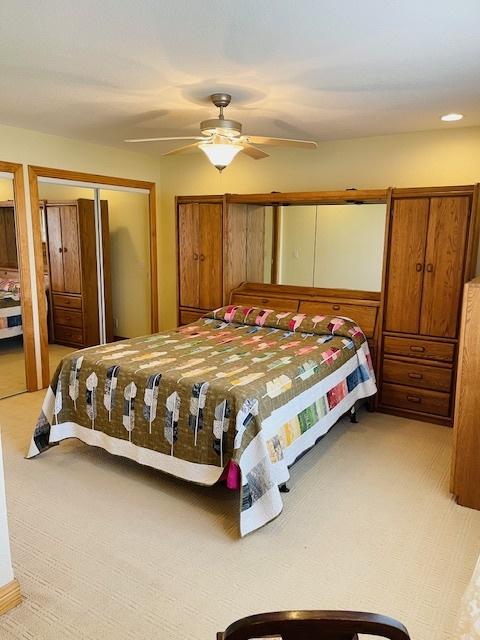 carpeted bedroom with ceiling fan