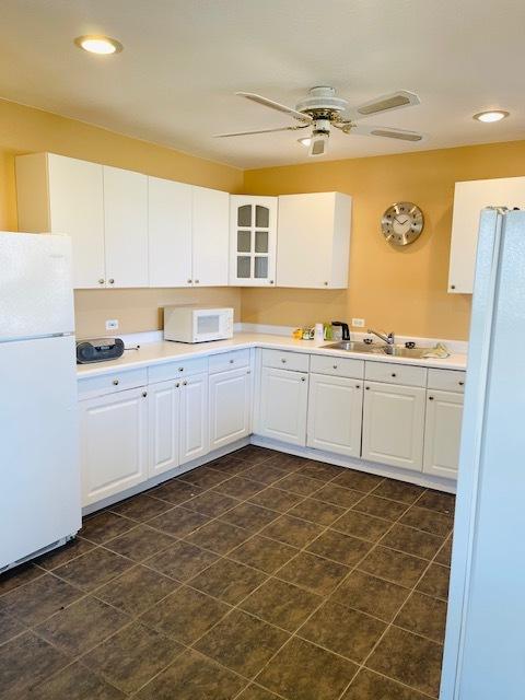 kitchen featuring ceiling fan, white cabinetry, white appliances, and sink