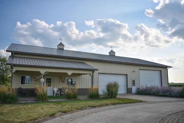 exterior space featuring a lawn, a porch, and a garage