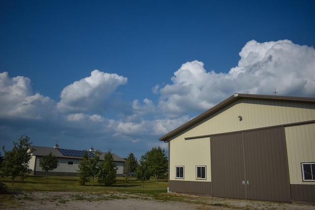 view of home's exterior featuring an outbuilding