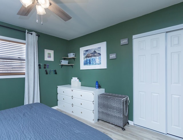 bedroom with a closet, light hardwood / wood-style flooring, and ceiling fan