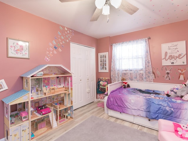 bedroom featuring ceiling fan, a closet, and wood-type flooring