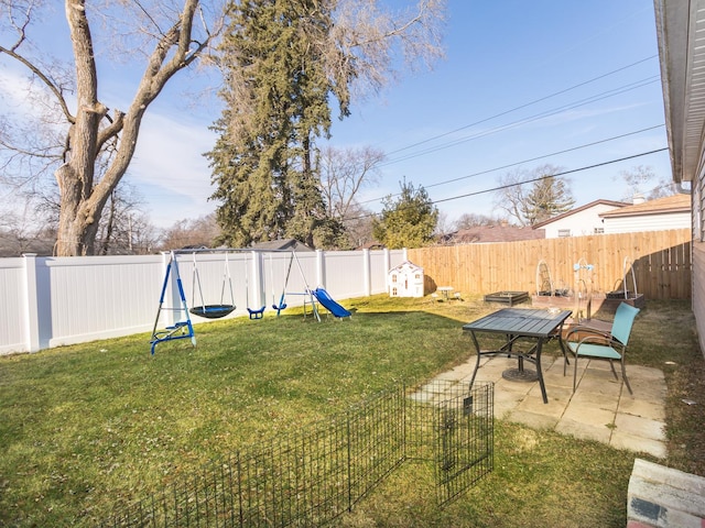 view of yard featuring a playground and a patio area