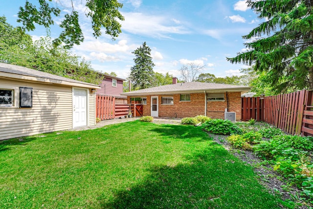 rear view of house featuring a lawn