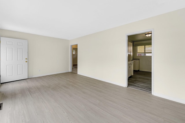 unfurnished room with light wood-type flooring