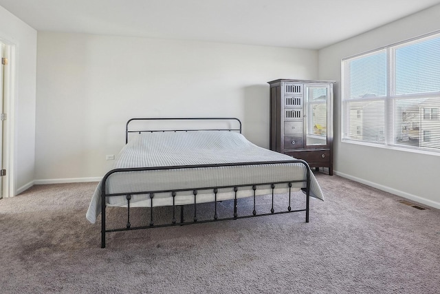 bedroom with carpet flooring and multiple windows