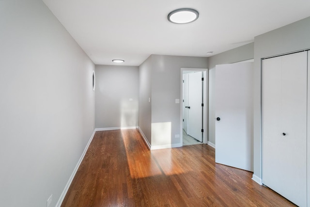 corridor featuring hardwood / wood-style floors