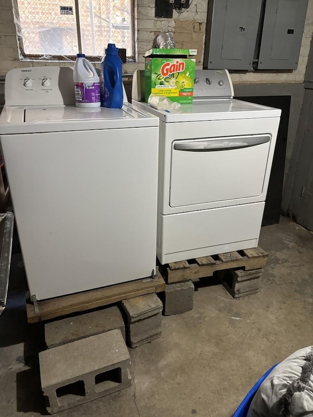 laundry room featuring electric panel and washer and clothes dryer