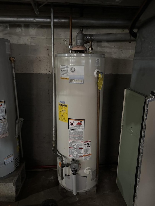 utility room featuring water heater