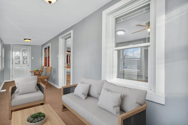 carpeted living room featuring ceiling fan