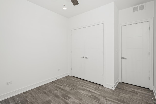 unfurnished bedroom featuring ceiling fan, a closet, and wood-type flooring