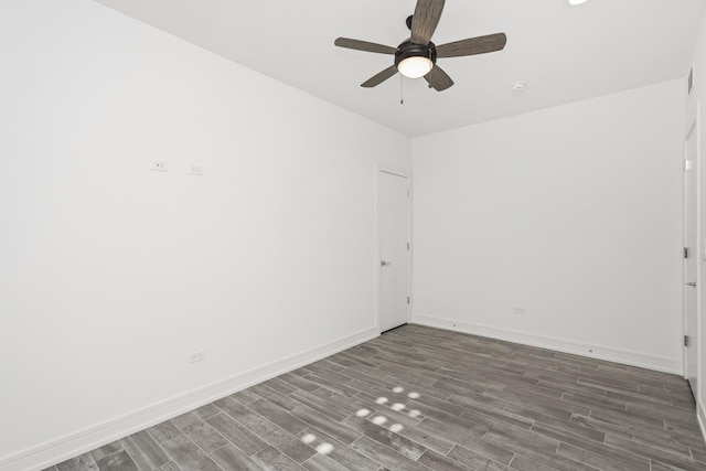 spare room featuring dark hardwood / wood-style floors and ceiling fan