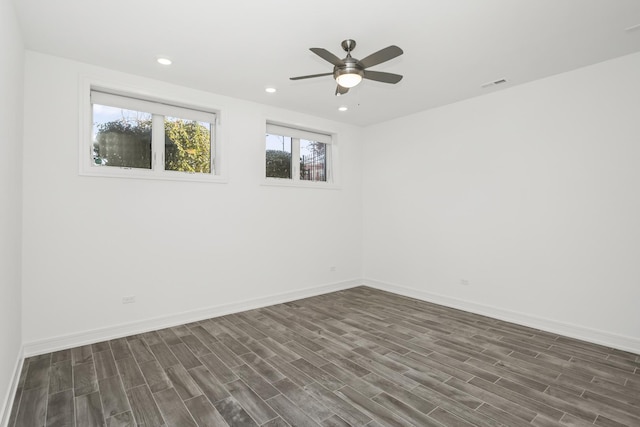 spare room with ceiling fan and dark wood-type flooring