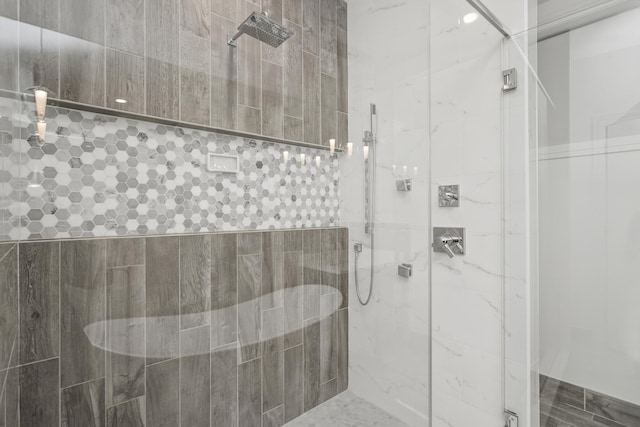 bathroom featuring a shower with shower door