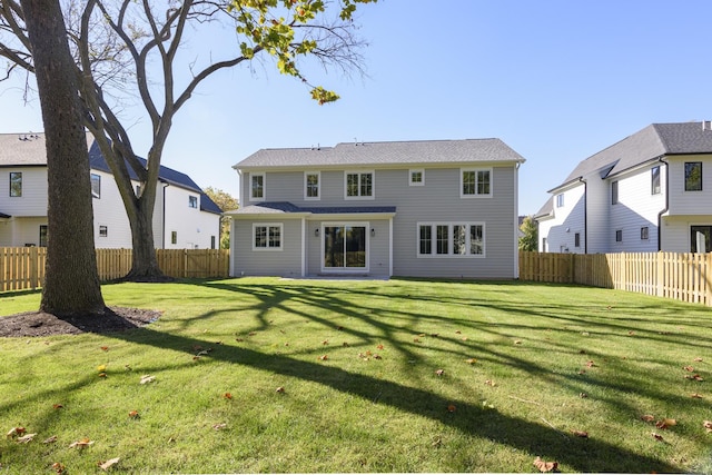 rear view of house with a lawn