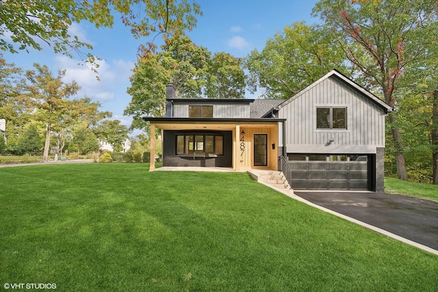 view of front of property with a front yard, a porch, and a garage