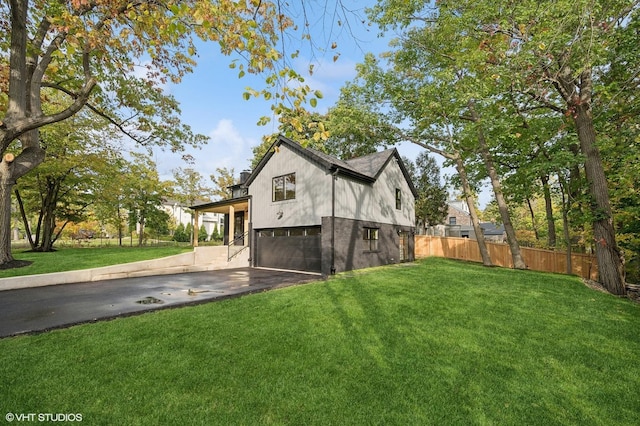 view of property exterior with a yard, a carport, and a garage