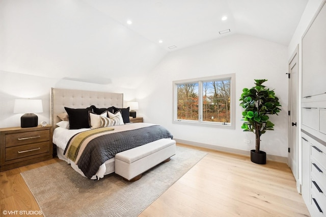 bedroom featuring light wood-type flooring and lofted ceiling