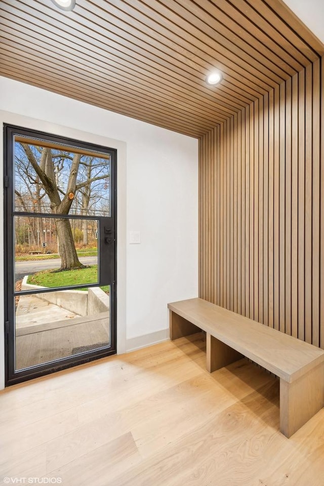 mudroom with light hardwood / wood-style flooring and wood ceiling