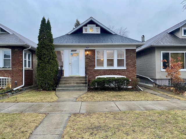 bungalow-style house with a front yard