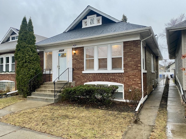 bungalow-style home with central AC unit