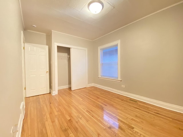 unfurnished bedroom featuring a closet and light hardwood / wood-style flooring