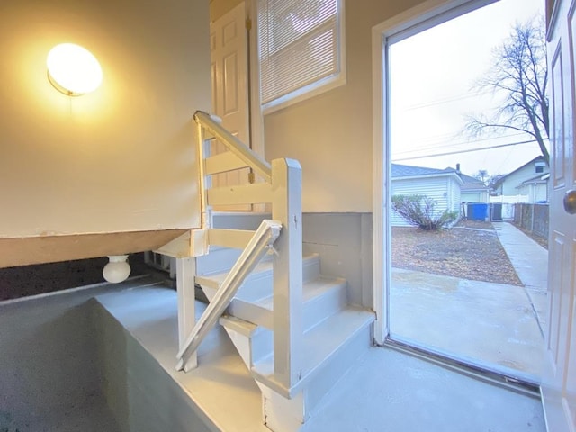 staircase featuring concrete floors