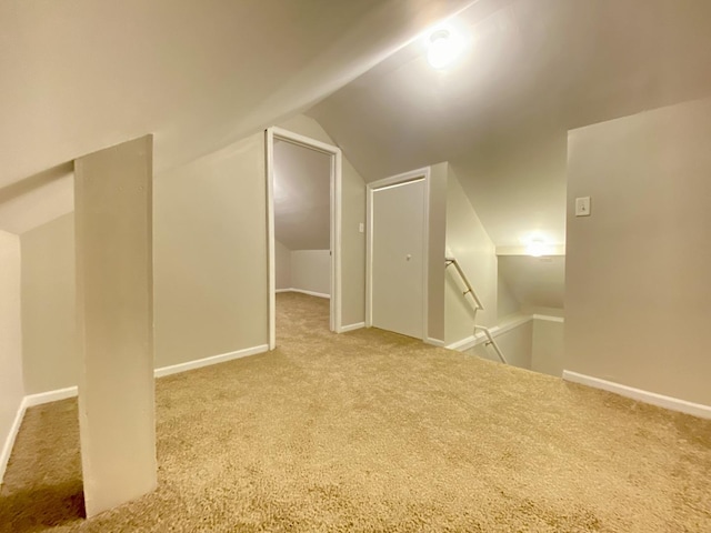 additional living space featuring carpet and vaulted ceiling