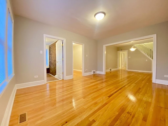 spare room with wood-type flooring