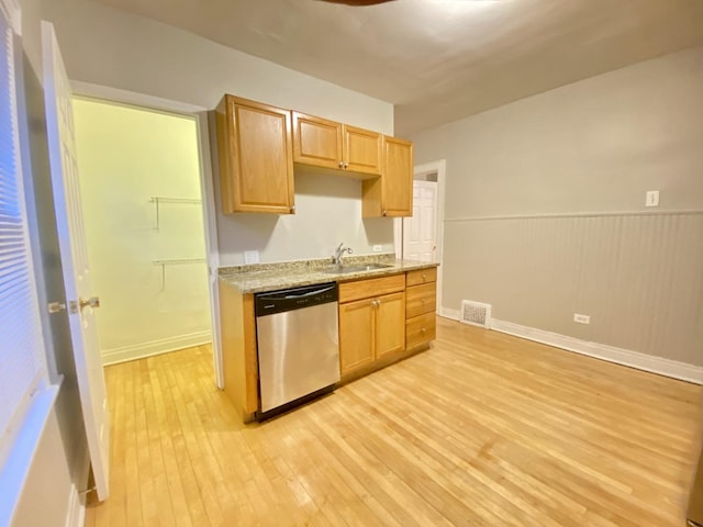 kitchen featuring light stone counters, light brown cabinets, sink, light hardwood / wood-style flooring, and stainless steel dishwasher