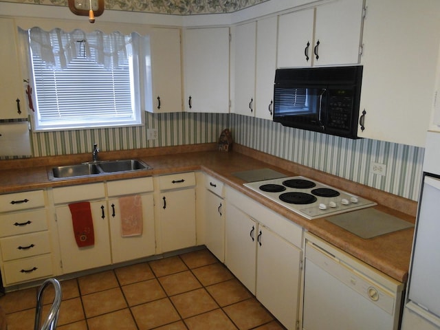 kitchen with sink, white cabinets, white appliances, and light tile patterned floors