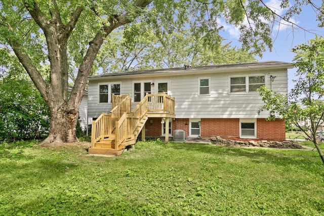 back of property featuring a yard and central air condition unit