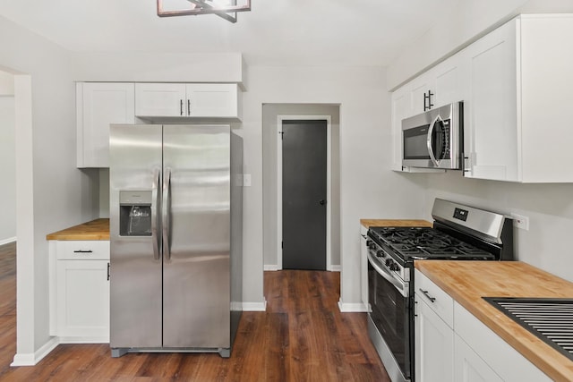 kitchen featuring butcher block counters, white cabinets, dark wood-type flooring, and appliances with stainless steel finishes