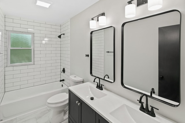 full bathroom featuring vanity, tiled shower / bath combo, and toilet