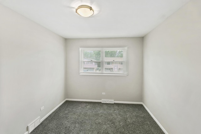 empty room with dark colored carpet