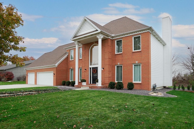 view of front of home with a front yard and a garage