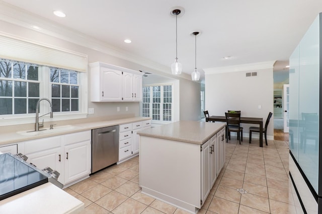 kitchen with sink, white cabinetry, dishwasher, a kitchen island, and decorative light fixtures