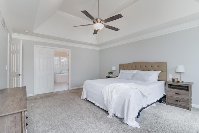 carpeted bedroom featuring crown molding, connected bathroom, ceiling fan, and a raised ceiling