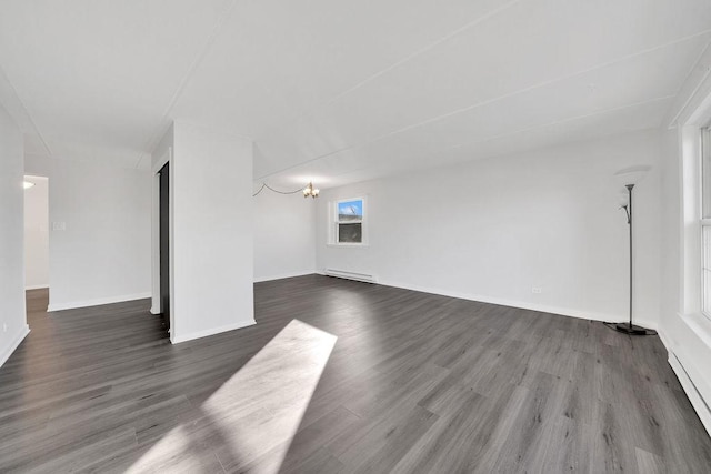 unfurnished room with a chandelier, dark wood-type flooring, and a baseboard radiator