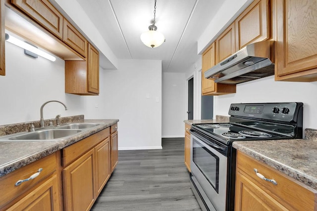 kitchen with sink, dark wood-type flooring, ventilation hood, decorative light fixtures, and black range