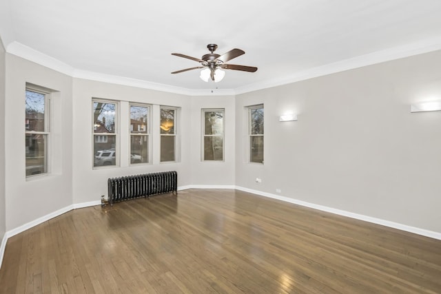 unfurnished room featuring radiator, ceiling fan, ornamental molding, and hardwood / wood-style flooring