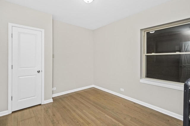 empty room with hardwood / wood-style flooring