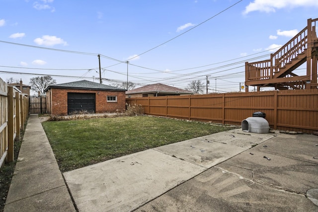 view of yard featuring an outbuilding and a garage