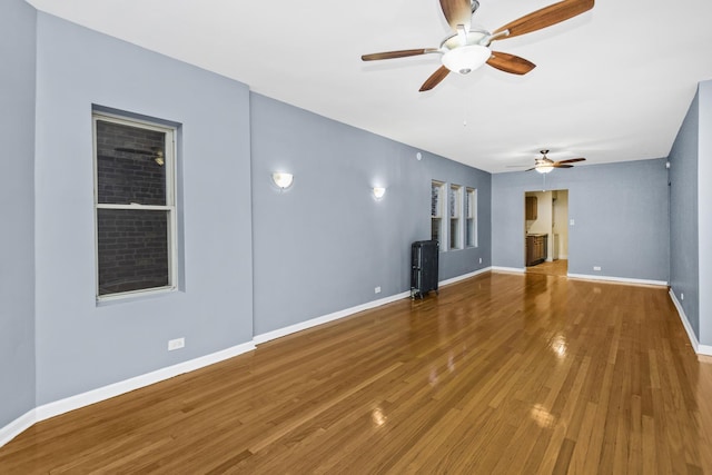 spare room with wood-type flooring and radiator