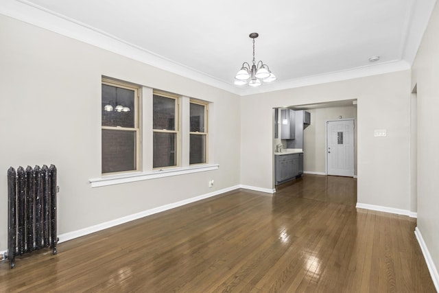 unfurnished dining area with ornamental molding, sink, a chandelier, radiator heating unit, and dark hardwood / wood-style floors