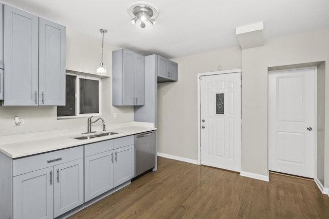 kitchen featuring dishwasher, gray cabinets, sink, and decorative light fixtures