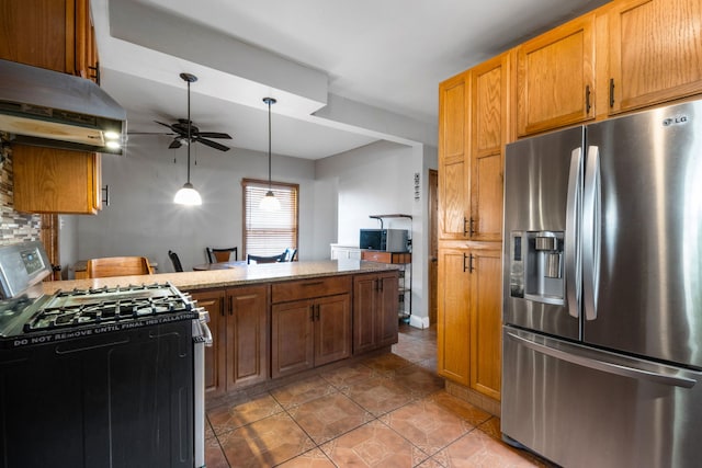 kitchen featuring ceiling fan, light stone countertops, stainless steel refrigerator with ice dispenser, backsplash, and white range with gas cooktop