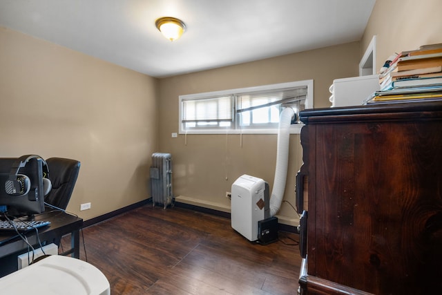 office area featuring radiator and dark hardwood / wood-style flooring